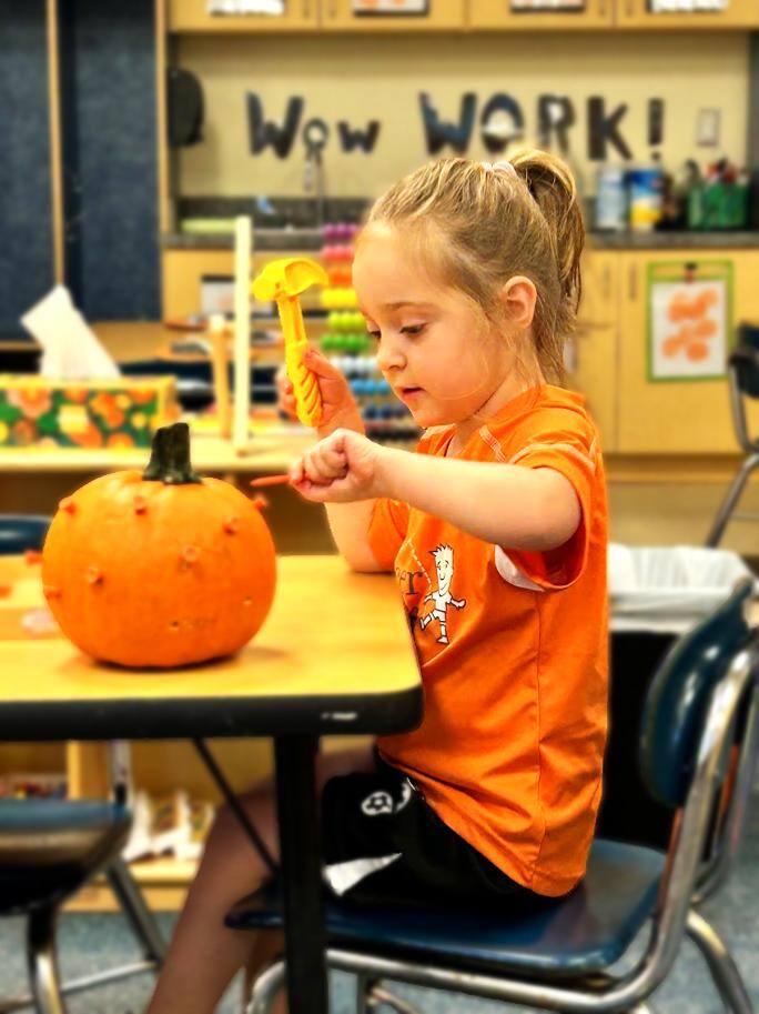 Pre-K working with pumpkins